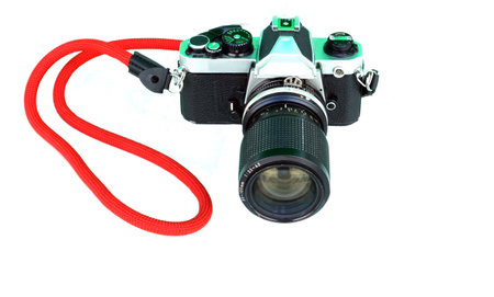 A retro film camera with red strap isolated on a white background, retro vintage concepts.の写真素材
