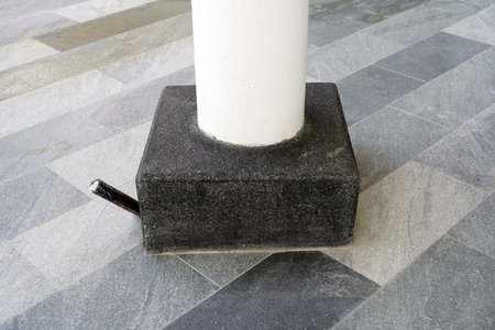 The black stone column on the floor of the building floor, architecture detail.の写真素材