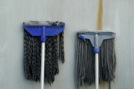 Cleaning two mop on concrete wall background, cleaning and housework concept.の写真素材