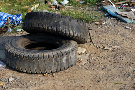 Old car tires left in the pile garbage area, environment concepts.の写真素材