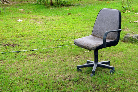 Office chair in the garden with grass and sky background, stock photoの写真素材