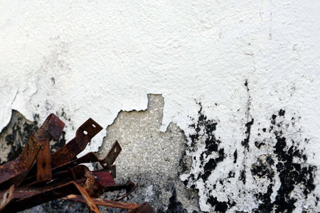 rusty metal on white concrete wall, grunge background for designの写真素材