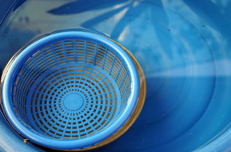 blue plastic basket, closeup of photo with soft focusの写真素材