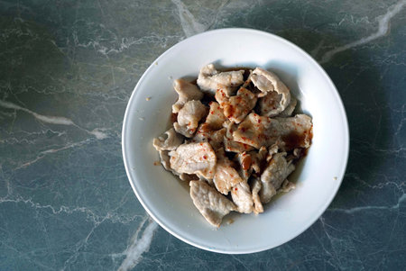 stir-fried pork with spicy sauce in white dish backgroundの写真素材