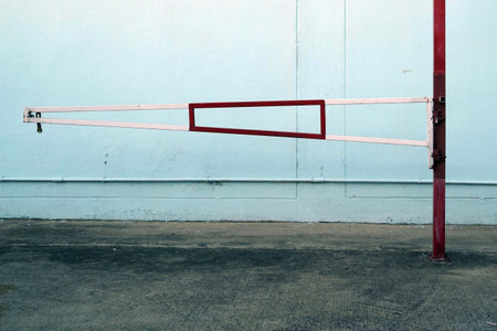 Empty parking lot with red barrier on blue wall backgroundの写真素材