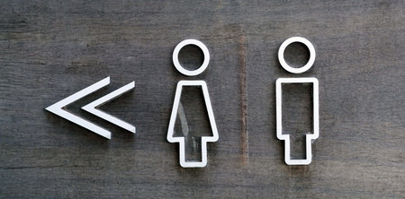 A male and female toilet sign on old wooden background, facility concepts.の写真素材