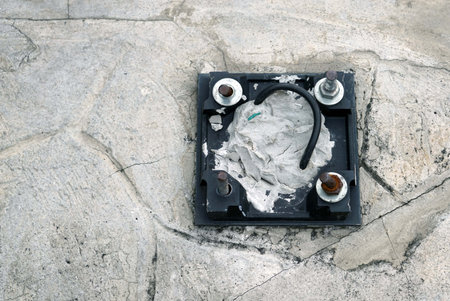 Electrical outlet on the concrete floor. Close-up view.の写真素材