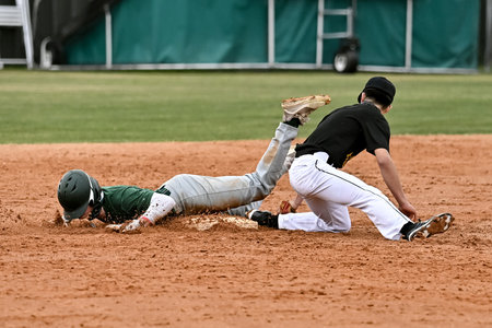 Young boys making exciting plays during a baseball gameの写真素材