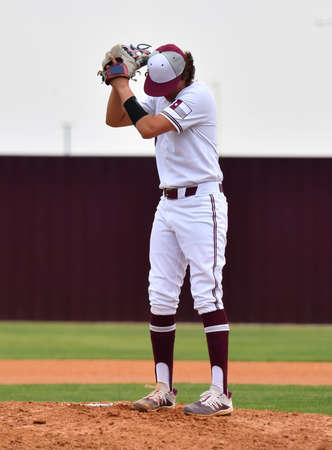 Action photo of high school baseball players making amazing plays during a baseball gameの写真素材