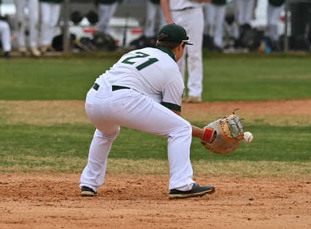 Action photo of high school baseball players making amazing plays during a baseball game