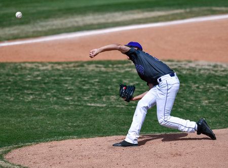 Action photo of high school baseball players making amazing plays during a baseball gameの写真素材
