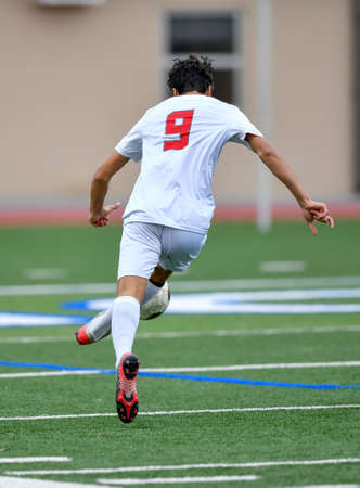 Athletic boy making amazing plays during a soccer gameの写真素材