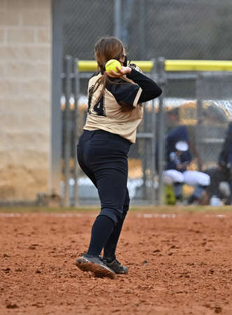 Athletic girls in action playing in a softball gameの写真素材