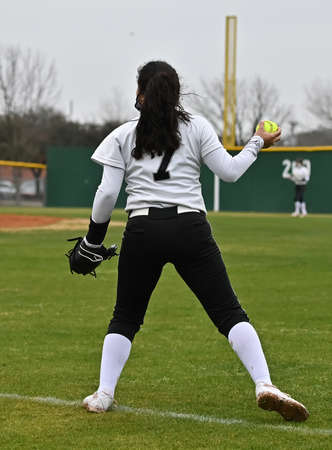 Athletic girls in action playing in a softball gameの写真素材