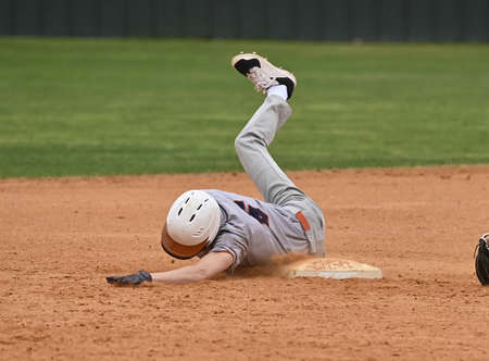 Action photo of high school baseball players making amazing plays during a baseball game
