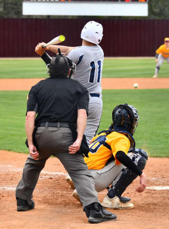 Action photo of high school baseball players making amazing plays during a baseball gameの写真素材