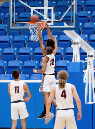 Young high school athletes making great basketball plays during a game