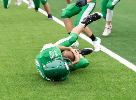 Great action photos of high school football players making amazing plays during a football gameの写真素材