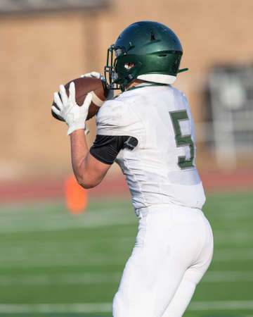 Great action photos of high school football players making amazing plays during a football gameの写真素材