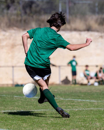 Athletic boy making amazing plays during a soccer gameの写真素材