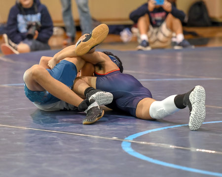 Boy wrestlers competing in a wrestling meetの写真素材