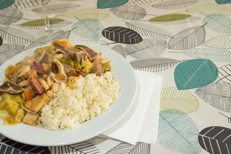 Homemade "Feijoada" ready to eat. It is a typical portuguese dish made of boiled white beans, vegetables, beef and pork meats served with rice.の写真素材