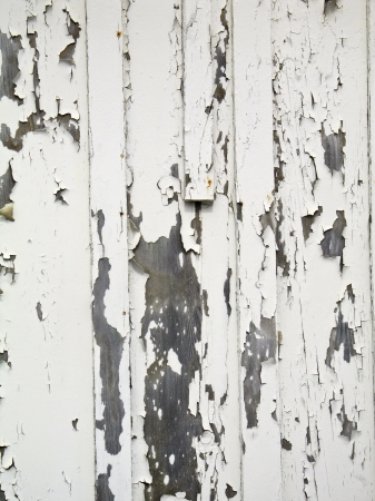 Rough textured old wooden wall with peeling paintの写真素材
