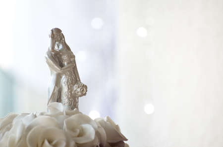 Marzipan figure of married couple on wedding cake.の写真素材