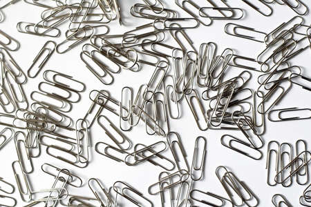 Silver office paper clips on white backgroundの写真素材