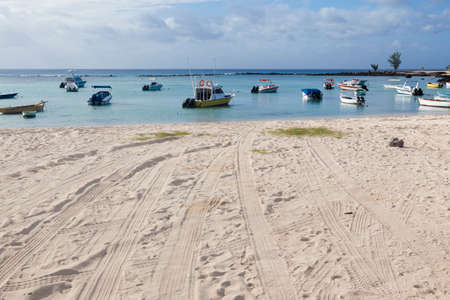 Fishing boats in sea at sandy beach on Mauritius island