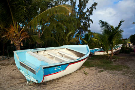 Rowboats in ocean on Mauritius island at sundownの写真素材