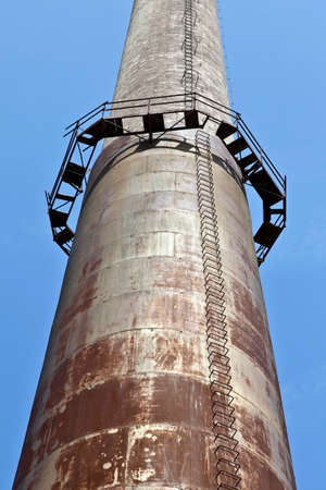 Chimney in old industrial steel mill factoryの写真素材
