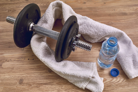 Concept fitness equipment with dumbbell, bottle of water and towel.の写真素材
