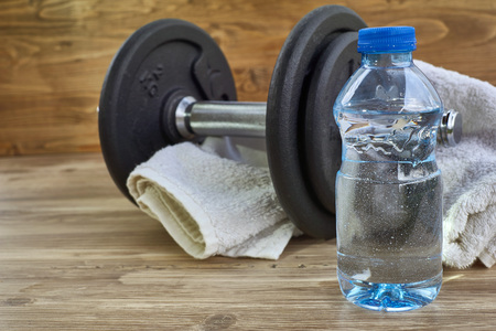 Concept fitness equipment with dumbbell, bottle of water and towel.の写真素材