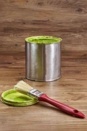green paint can with a brush on a rustic wooden backgroundの写真素材