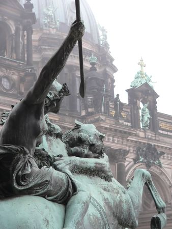 Amazon on Horseback Fighting a Lion sculpture in Front of Altes Museum in Berlin Cathedral in rearの写真素材