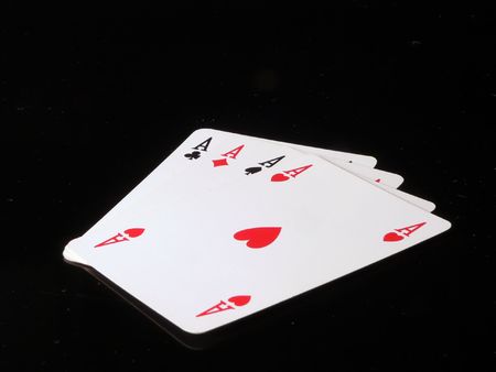 Four aces meaning poker in a black background