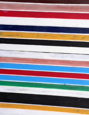 A wooden table painted with rainbow colors