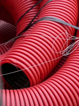 Red curvilinear tubes for constructionの写真素材