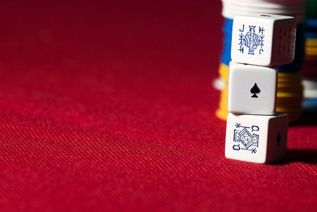 Poker's Dice and chips on a red cover.の写真素材