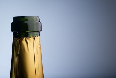 Golden  bottleneck against a bluish background. Concept for new years r christmas partyの写真素材