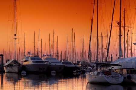 Extra Large Luxury yachts rest in the port at sunsetの写真素材