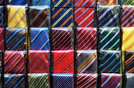 rows of colored neckties are displayed in the market of San Lorenzo,Florenceの写真素材