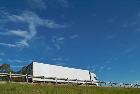 Fast moving truck with white container on highway, blurred because of motionの写真素材