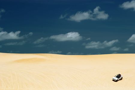 Beach-buggy with its tourist passengers races along the dunes at Genipabu near Natal, northeast Brazilの写真素材