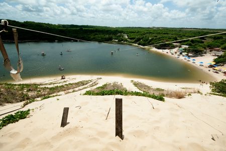Tourists flight in the lagoon of jacuma on an a hand-made leather seat is hunging from steel ropesの写真素材