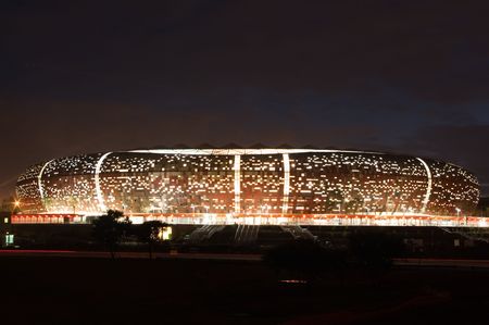 South africa will host the 2010 world cup of soccer. Jewel of the crown is the soccer city in soweto-johannesburg, and the stadium capable of 80000 people will host the first and final match of the competition. Here a nightshot of the stadium.のeditorial素材
