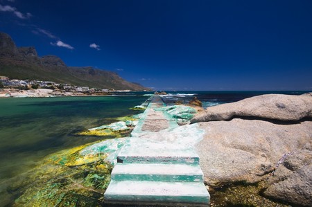 Little bay near the beach of camps bay with a marvelous emerald sea and the twelve apostles mountain...