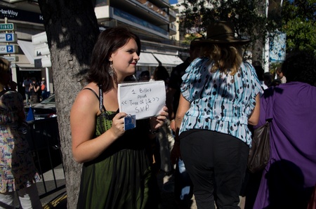 CANNES, FRANCE - MAY 16:  girl looking for an invitation outside  the Palais des Festivals during the 64th Annual Cannes Film Festival on May 16, 2011 in Cannes, France.のeditorial素材