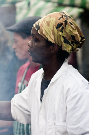 LONDON, ENGLAND - AUGUST 28: Black man cooks chicken wings at a Food's stall at the Notting Hill Carnival on August 29, 2011 in London, England.のeditorial素材
